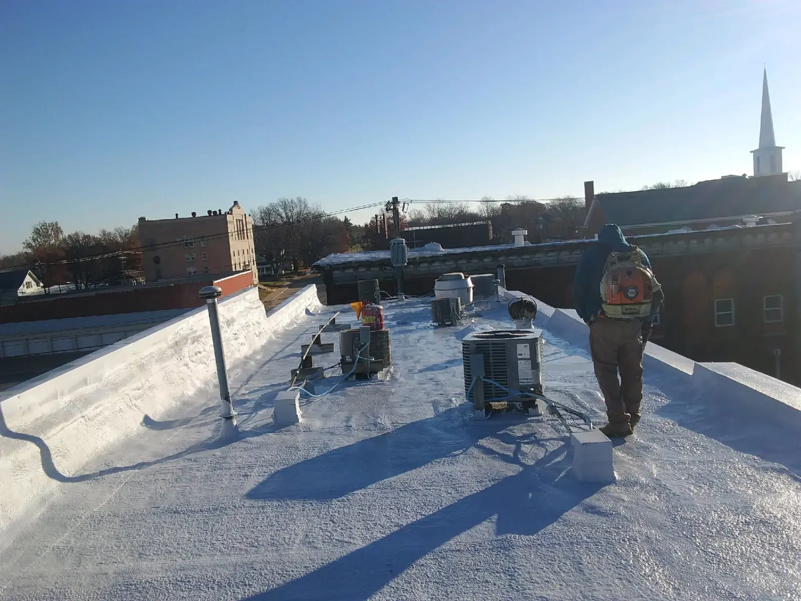 Finished white-coated flat commercial roof by JHC overlooking downtown Kirksville